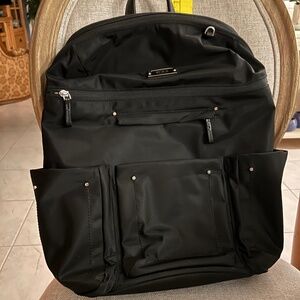 TUMI backpack, black,  with trolley sleeve...suitable for man or woman...
